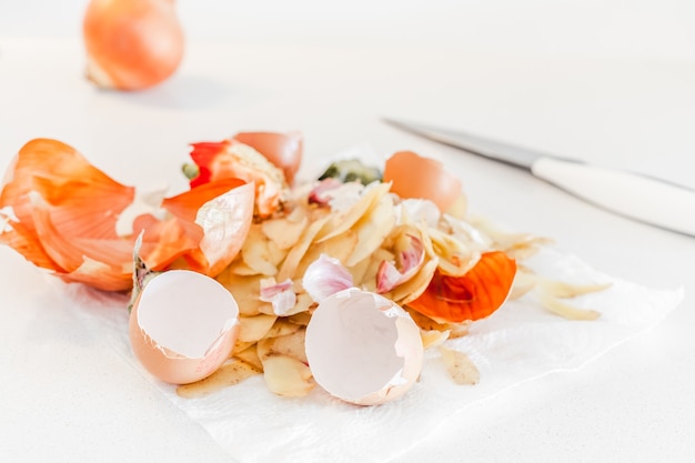 Organic home cooking food waste ready to compost. Ecological concept. Food leftovers, Vegetable Peelings on kitchen table. Environmentally responsible behavior, waste management, recycling garbage.