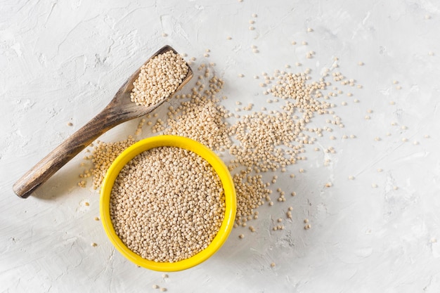 Organic quinua cereal in color bowl on white background