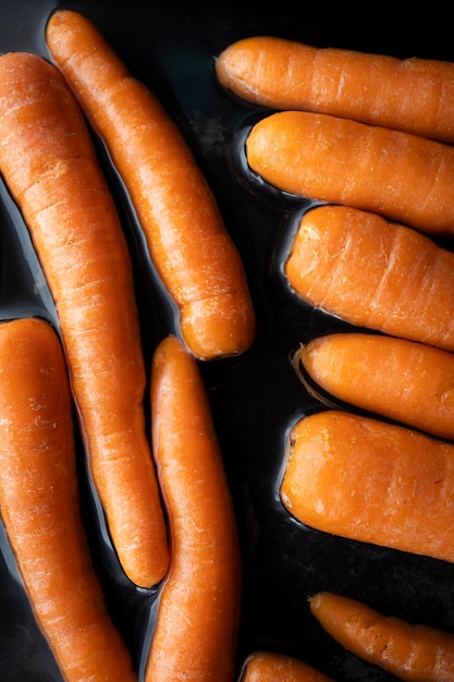 Organic raw carrots in water