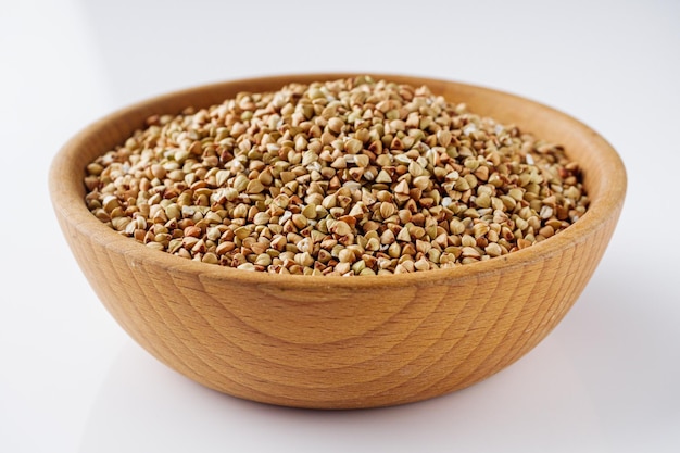 organic raw green buckwheat on a white background