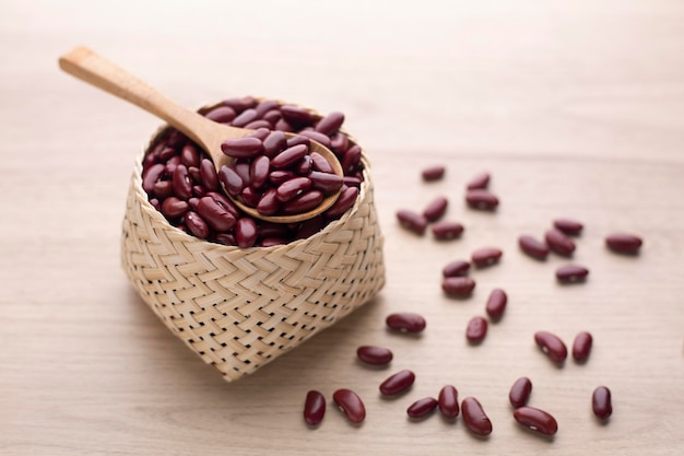 Organic red kidney bean in basket on wood table and wooden spoon Protein nutrition ingredient