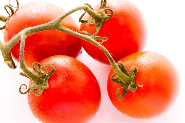 Organic Roma tomatoes on white background.