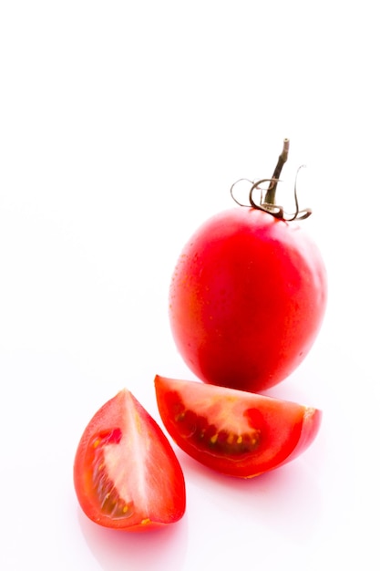 Organic Roma tomatoes on white background.