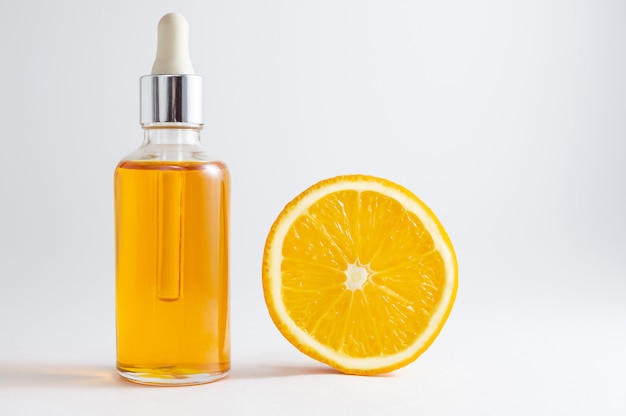 Organic SPA cosmetics with herbal ingredients: vitamin C serum in cosmetic bottle with dropper.