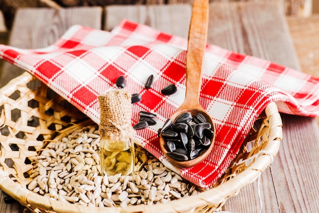 Organic sunflower seeds and flowers on wooden table