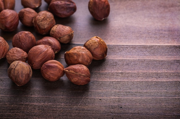 Organized copyspace hazelnuts on vintage wooden board