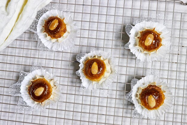 Oriental Algerian sweet cookies named dziriettes in Arabic language on grill