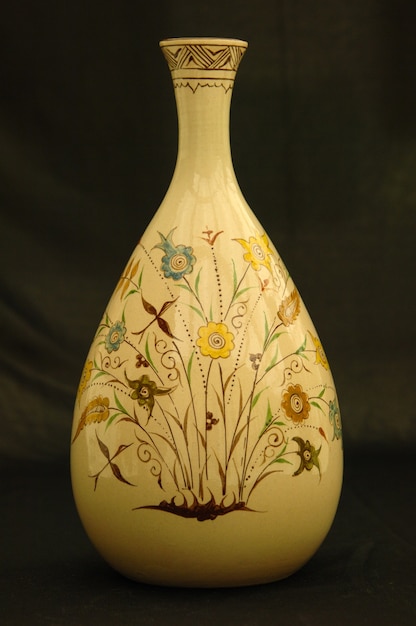 Oriental antique ceramic vase on a black background closeup