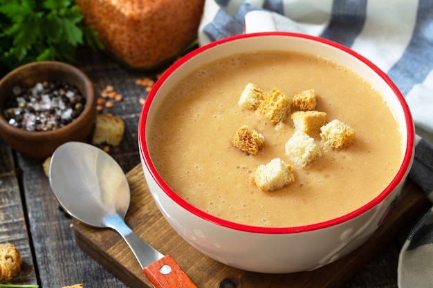 Oriental or Arabic cuisine Hot lentil puree soup on a rustic wooden table