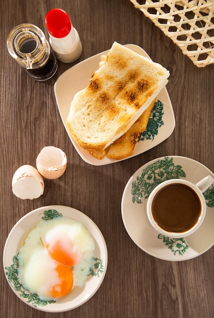 Oriental breakfast set in Malaysia consisting of coffee nasi lemak toast bread and halfboiled egg