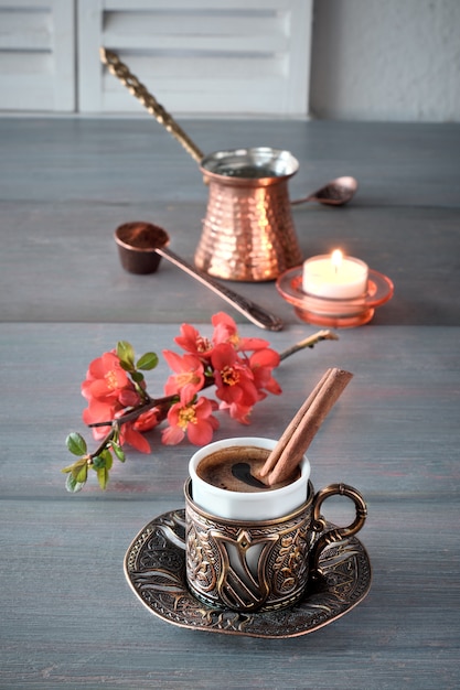 Oriental coffee cooked in traditional Turkish copper coffee pot and  served in a matching cup