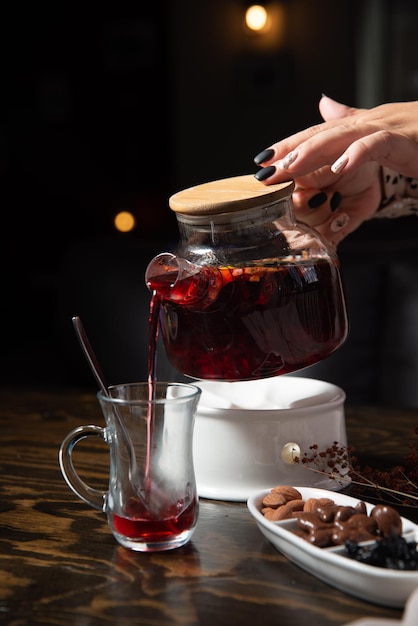 oriental sweets and fruit tea on a wooden table with a dark background