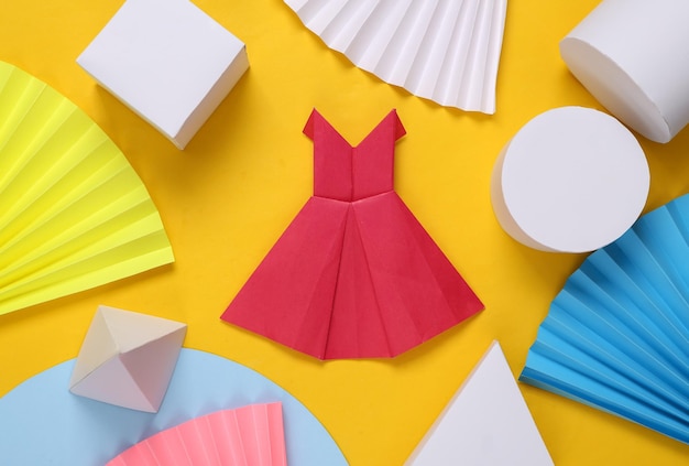 Origami dress on yellow abstract background with geometric shapes Minimalism Concept art Creative layout