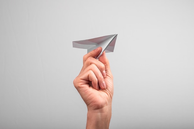 Origami paper plane in hand Sending message starting business startup project concept