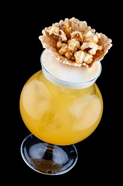 Original cocktail with orange and popcorn on a dark background