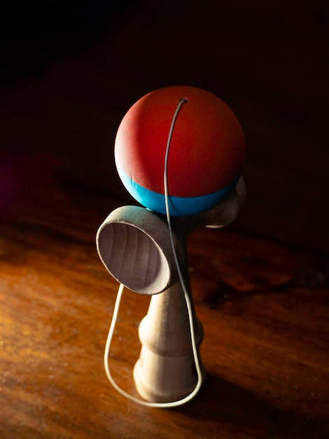 The original Kendama An ancient traditional wooden Japanese skill toy for children Has three cups spike and ball selective focus