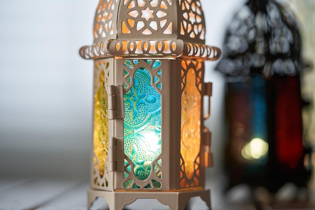 Ornamental Arabic lantern with burning candle glowing in dark Muslim holy month Ramadan Kareem festive