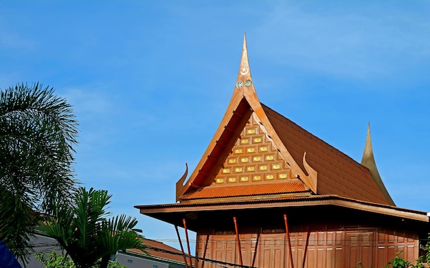 Ornate Gable Roof of Thai Traditional Wooden House with Islamic Art Motif