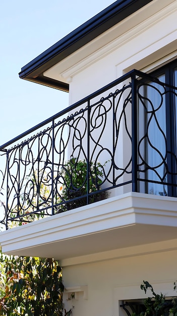 Photo ornate wrought iron balcony railing on a white modern home