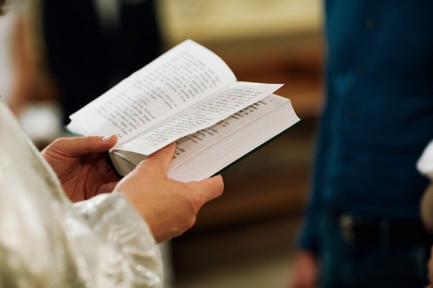 Orthodox Christian Priest and Holy Bible in the church. Epiphany ceremony rite.