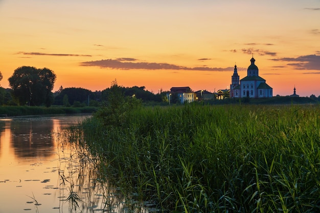 Orthodox church of Elijah the Prophet at the Kamenka river, Suzdal, Russia. Summer sunny day sunset.