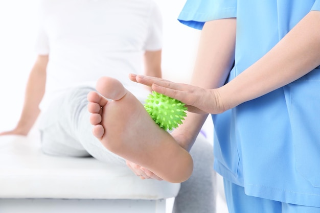 Orthopedist working with patient in clinic closeup