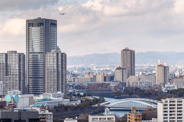 Osaka, Japan - February 21, 2014 : cityscape of Osaka with mountain in the background shot from Osaka Castle.