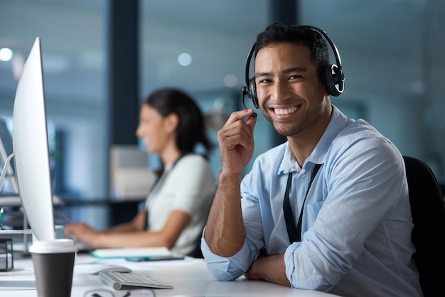 Our customer satisfaction rate says it all Portrait of a young man using a headset and computer in a modern office