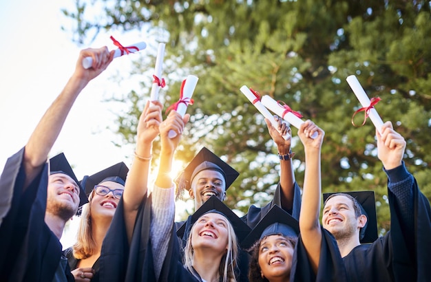 Our hard work paid off Shot of a group of graduates holding their diplomas up in the air