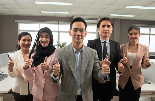 Our team of Asian businessmen believe in doing business,show symbol thump up