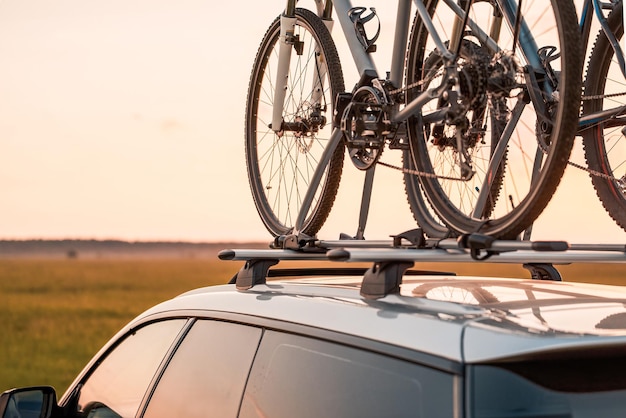 Outdoor Adventure Awaits Family Car with Bicycles Mounted on Roof Rack A vehicle with top mounted bikes