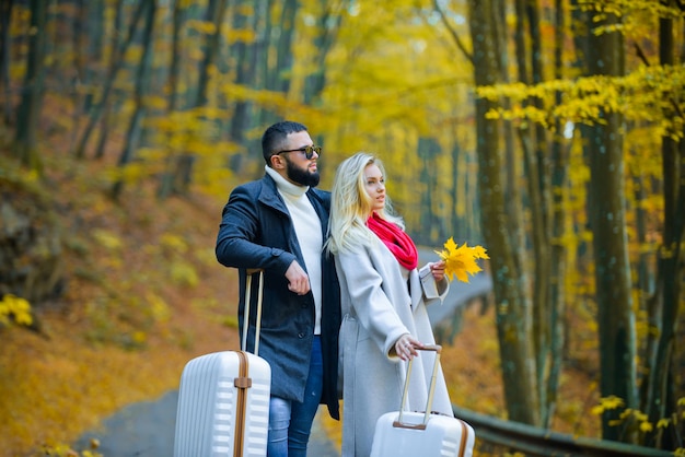 Outdoor autumn portrait of young beautiful fashionable couple Man and woman wearing stylish autumn c