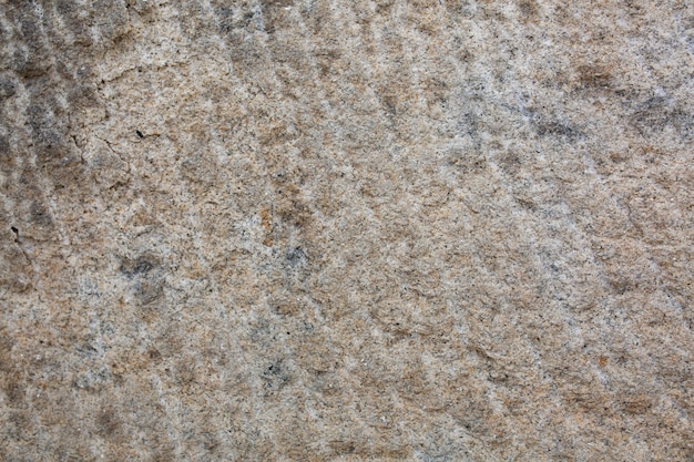 Outdoor beige rock wall. Closeup shot