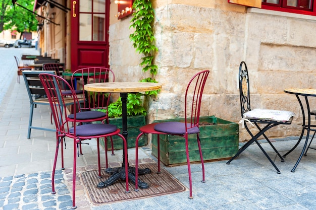 Outdoor cafe in the old town Chairs and table on empty terrace at cafe