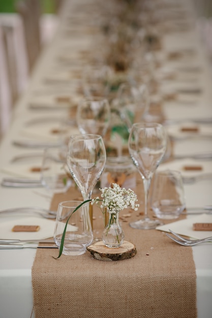 Outdoor catering dinner at the wedding with homemade garnishes decoration