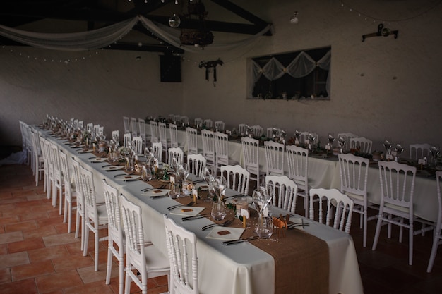 Outdoor catering dinner at the wedding with homemade garnishes decoration