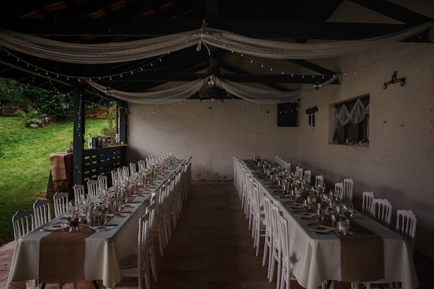 Outdoor catering dinner at the wedding with homemade garnishes decoration