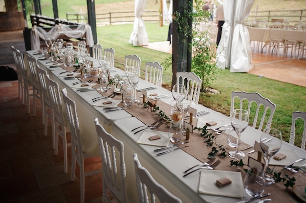 Outdoor catering dinner at the wedding with homemade garnishes decoration