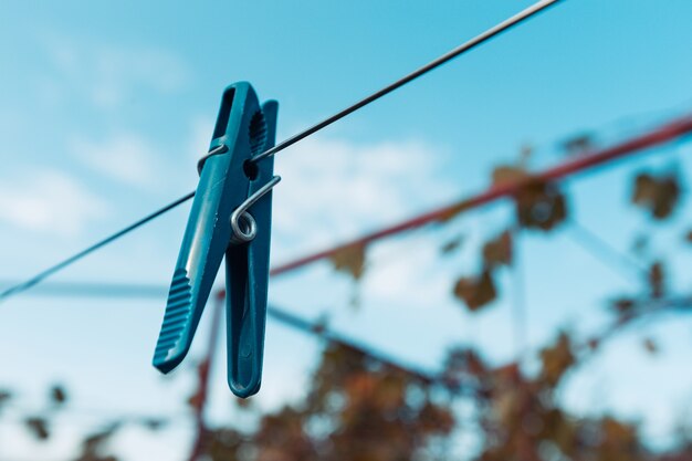 Outdoor clothesline with hanging clothespins. Concept of housework, chores, laundry and energy cost savings.