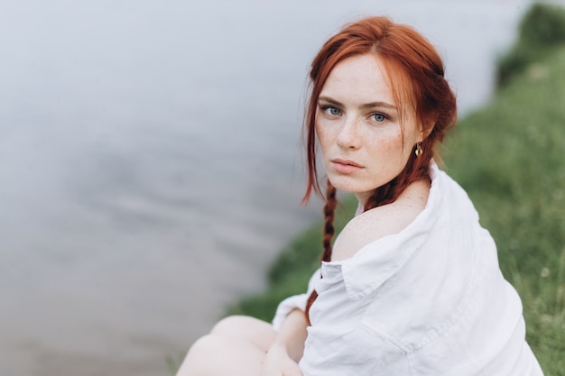 outdoor ginger woman portrait with pigtails