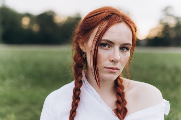 outdoor ginger woman portrait with pigtails