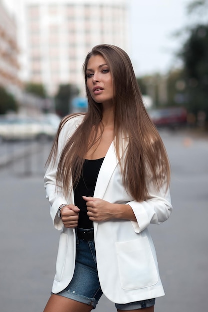 Outdoor lifestyle portrait of amazing glamorous luxury woman posing in city