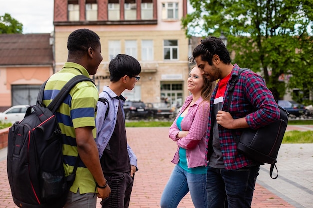 Outdoor meeting of cheerful multiethnic college friends