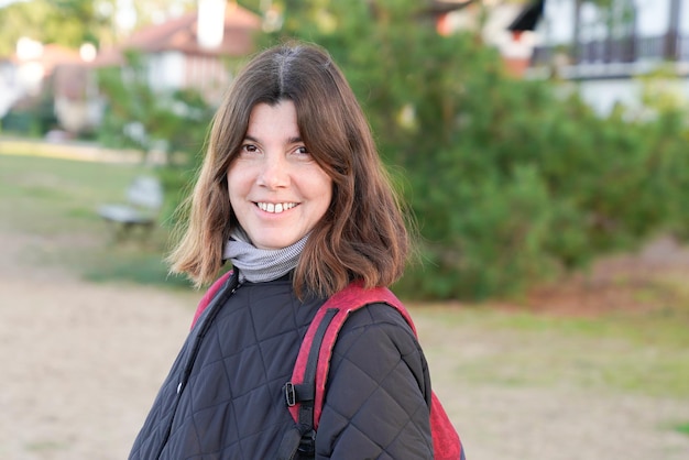 Outdoor middle aged portrait woman in winter autumn park