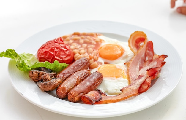 Outdoor natural sunlight of a traditional English breakfast with sunny side up eggtoasttomatoesbaconsausage and baked beans