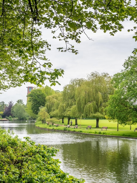 Outdoor park along Avon river in Stratford city in England with cloudy sky in morning