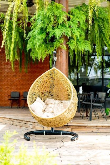 Photo outdoor patio with wicker swing chair