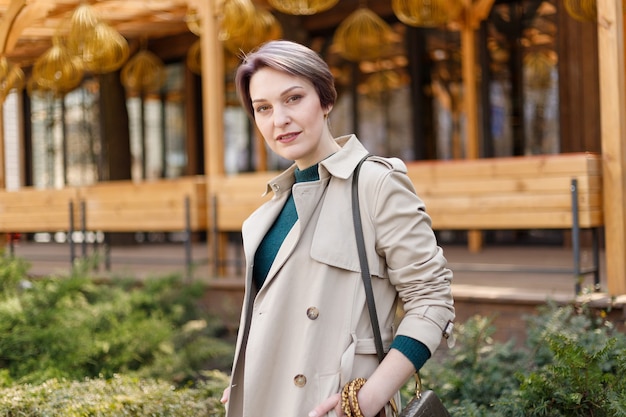 Outdoor portrait of an attractive stylish short cut woman