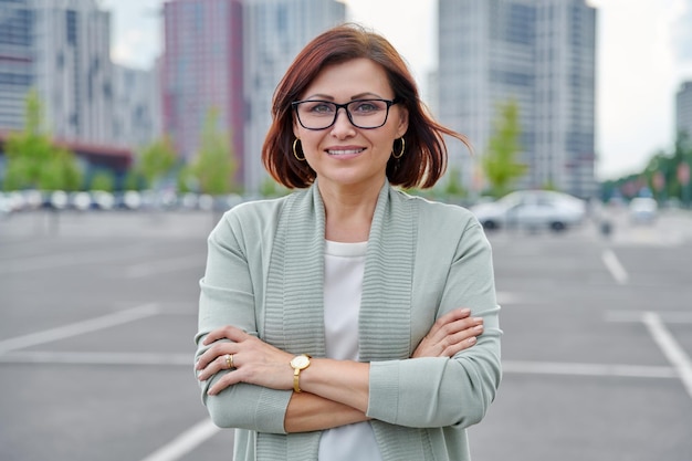 Outdoor portrait of confident middle age business woman