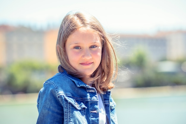 Outdoor portrait of cute young girl 10-11 year old